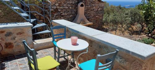 a table and chairs on a balcony with a table and a cup at Elgina Apartments2 MANI in Mína