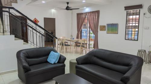 a living room with two chairs and a table at Johor Bahru 6 Bedrooms Corner House: Big & Comfort in Johor Bahru