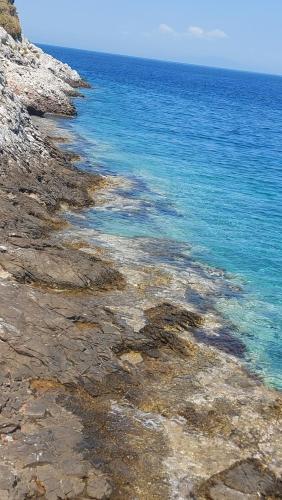a view of the ocean from a rocky shore at Elgina Apartments2 MANI in Mína