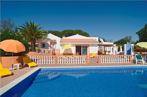 a villa with a swimming pool and a house at 609 Villa Mariposa in Lagos