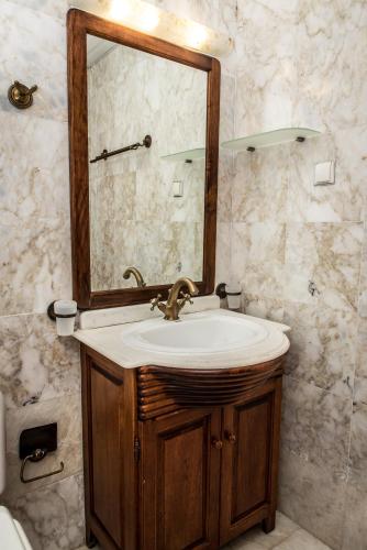 a bathroom with a sink and a mirror at Erodios Villas 1 in Gerani