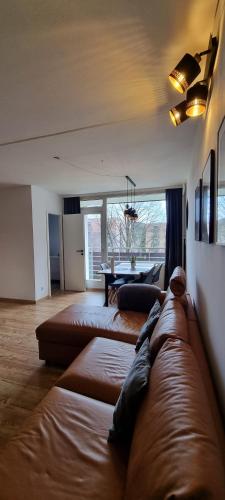 a living room with a brown couch and a table at FeWo Wanderlust in Altenau