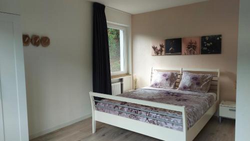a small bedroom with a bed with a window at Villa Bad Bertrich in Bad Bertrich