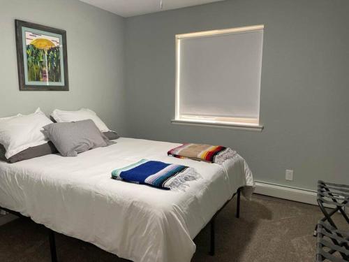 a white bed in a room with a window at The Aspen - in WPCO at 8488 ft elevation in Woodland Park
