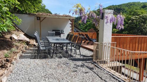 a patio with a table and chairs and a fence at Villa Bad Bertrich in Bad Bertrich