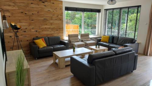 a living room with two couches and a table at Villa Bad Bertrich in Bad Bertrich