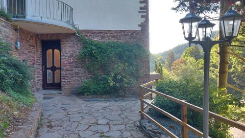 a brick building with a door and a street light at Villa Bad Bertrich in Bad Bertrich