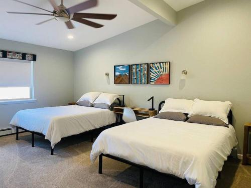 a bedroom with two beds and a ceiling fan at The Aspen - in WPCO at 8488 ft elevation in Woodland Park