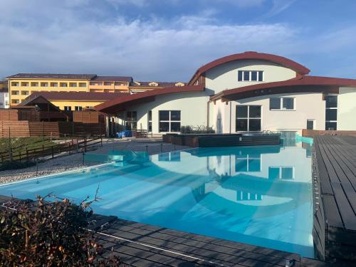 a large swimming pool in front of a building at Wellness & Spa Apartments Lipno - Frymburk in Frymburk