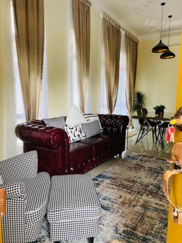 a living room with a leather couch and a table at THE PINE HOUSE in Kuala Berang