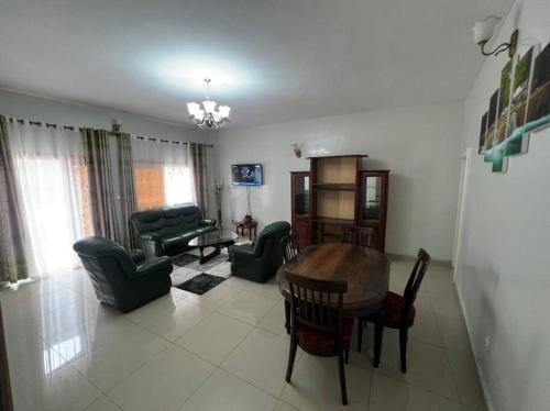 a living room with a table and chairs at Résidence Allégra in Yaoundé