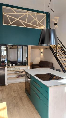 a kitchen with a blue and white counter top at Louisa in Dinard