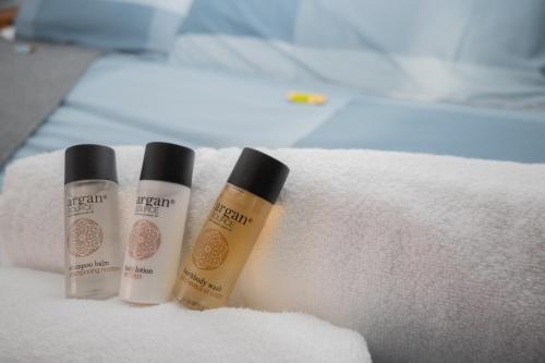 three bottles of sunscreen sitting on a white towel at Delfino in Pietrapertosa