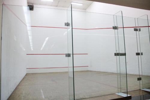 a room with glass doors in a white wall at The Maple Suite in Kuala Lumpur
