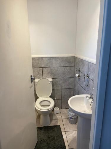 a bathroom with a toilet and a sink at 8 Challanor road in Yarm