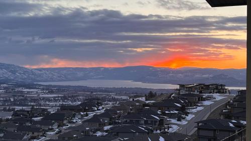arial view of a city with a sunset in the background at Kelowna new lake view 2bedrooms close BIG WHITE in Kelowna