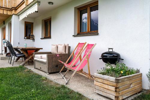 a group of chairs sitting outside of a house at Haus grüner Wald in Bartholomäberg