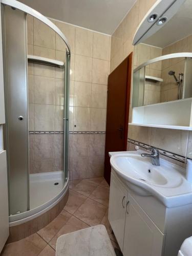 a bathroom with a sink and a shower at House Roca in Vodice