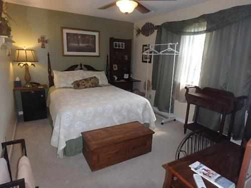 a bedroom with a bed and a television in it at Poolside Paradise in Navarre