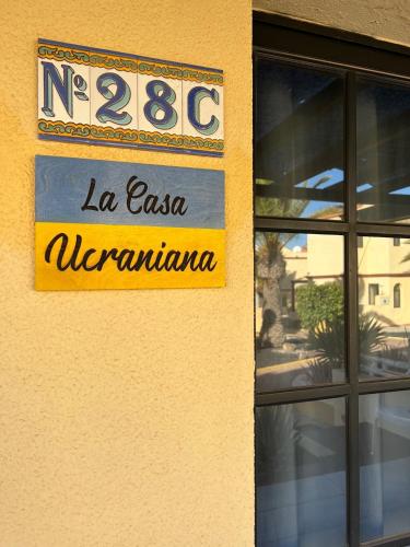 a sign on the side of a building at Casa Ucraniana Wi-Fi fibra in Costa Calma