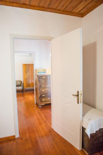 an empty room with a bed and a dresser at Mikros Paradisos Pelion in Áyios Vlásios