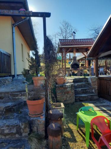 a backyard with a stone patio with a fire pit at Domceky Holiday in Liptovský Trnovec