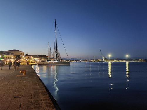 a marina at night with boats in the water at Hotel Avra in Preveza