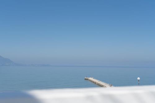 a pier in the water with the ocean at Naro Suites and Rooms in Bacoli