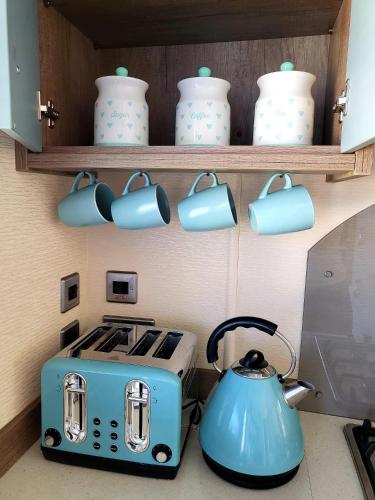 a kitchen with a tea kettle and a toaster at Luxury Seaside Retreat Holiday Home - Shorefield Country Park in Downton