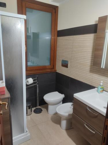 a bathroom with a toilet and a sink and a shower at Casa Stella in Torre Grande