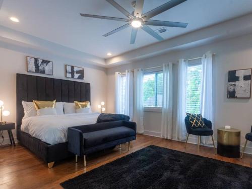 a bedroom with a large bed and a ceiling fan at Five75Lux ATL King Bed & Game Room Downtown in Atlanta
