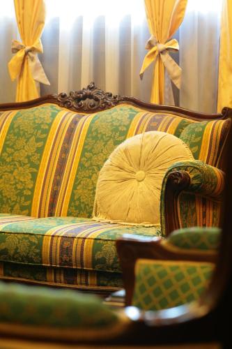 a couch with a pillow on it in a room at Dukes Hotel Nakasu in Fukuoka