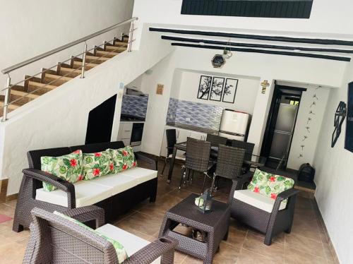 a living room with a couch and chairs and a table at Casa de Descanso in Melgar