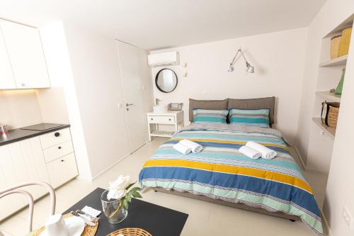 a bedroom with a bed with blue and yellow stripes at Piran Holiday Apartments in the city center in Piran