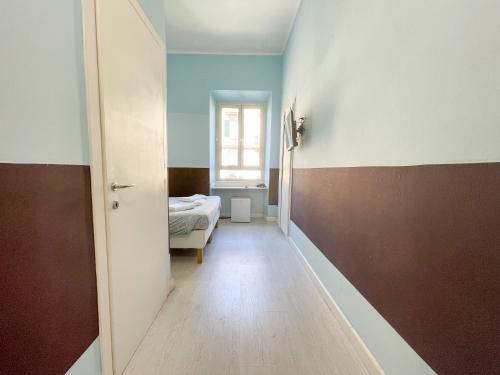 a hallway with a room with a bed and a door at Prati Boutique Suites in Rome