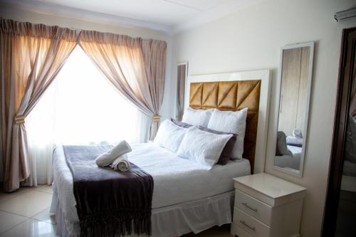 a bedroom with a bed with a large window at ANGELOCEAN GUEST HOUSE in Witbank