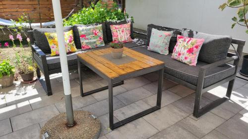 a table and chairs with pillows on a patio at Hostel Center in Ulcinj