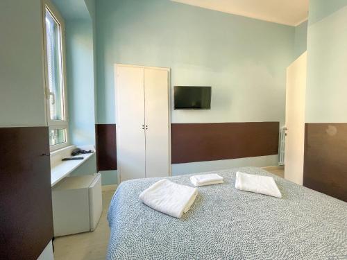 a bedroom with a bed with two towels on it at Prati Boutique Suites in Rome