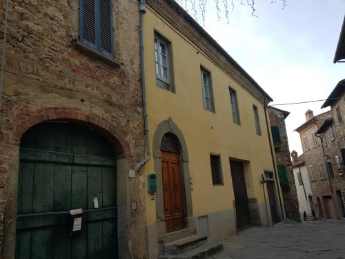a building with two garage doors in a street at Roma 88 in Lucignano
