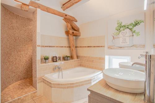 a bathroom with a tub and a toilet and a sink at Le clos des vignes in Villefranche-de-Rouergue