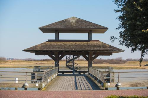 a wooden boardwalk with a gazebo in a park at Villa Louise Nieuwpoort-Bad in Nieuwpoort