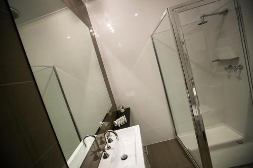 a bathroom with a shower and a sink at Gallery Apartments in Warrnambool