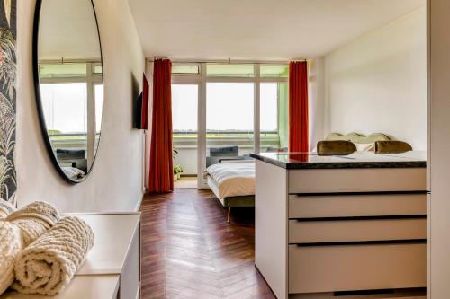 a bedroom with a bed and a mirror at Apartment im Olympia Hotel Schilksee in Kiel