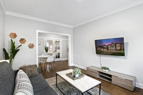 a living room with a couch and a table at 2BR Stylish Apartment in Avondale close to Shops - Roscoe 1W in Chicago