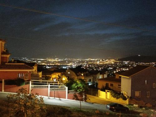 a view of a city at night at AT VISTA GRANADA in Monachil
