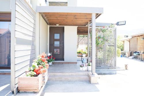 a front door of a house with flowers at Luxury Apartments in Platánion