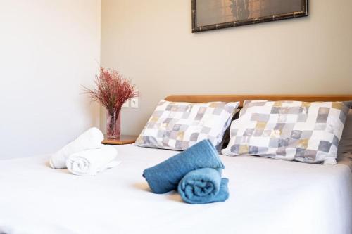 a bed with towels and pillows on it at Luxury Apartments in Platánion