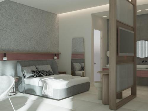 a bedroom with a bed and a bathroom at Charisma Boutique Hotel in Parga