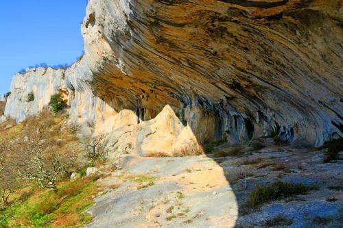 a painting of a rocky mountain with a dirt road at Istrian Experience in Sočerga