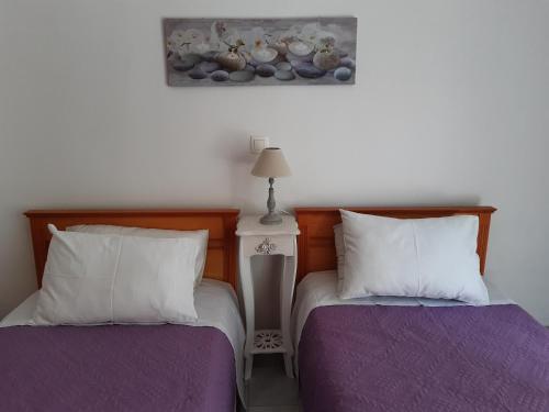 two beds sitting next to each other in a bedroom at Renovated apartment in Adelianos Kampos in Adelianos Kampos